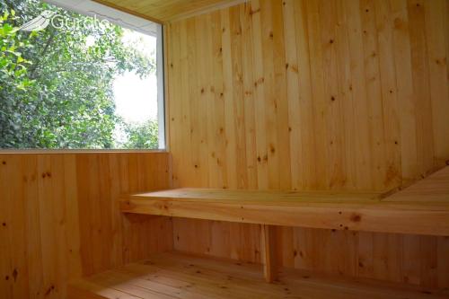 a wooden sauna with a window in it at Gyrola Birding Hotel Boutique in La Mesa
