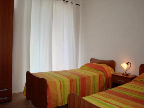 a bedroom with two beds and a window at Alba Splendente in Santa Caterina Dello Ionio Marina