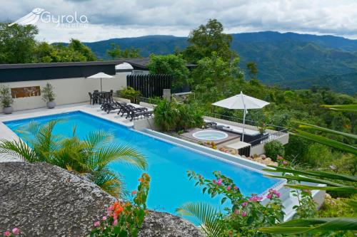 a swimming pool with a view of the mountains at Gyrola Birding Hotel Boutique in La Mesa