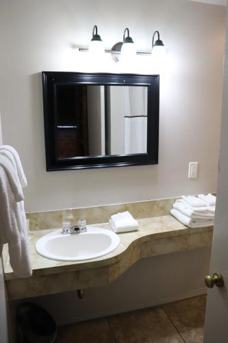 a bathroom with a sink and a mirror at Lone Fir Resort in Cougar