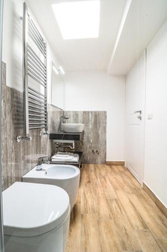 a bathroom with a white toilet and a sink at Bella 'Mbriana in Ercolano