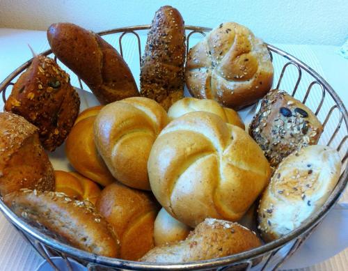 a basket of different types of bread and pastries at Haus Tirolerland in Oetz