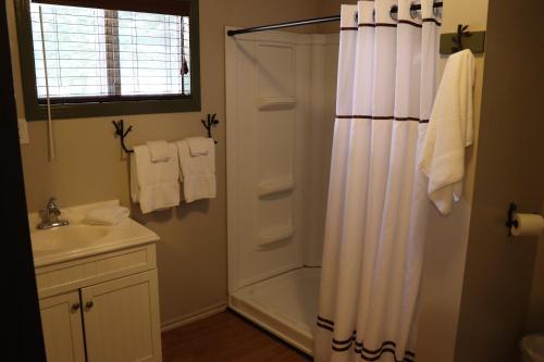 a bathroom with a shower and a sink at Lone Fir Resort in Cougar