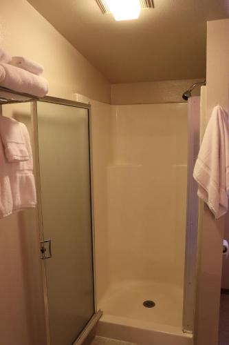 a shower in a bathroom with a glass shower stall at Lone Fir Resort in Cougar