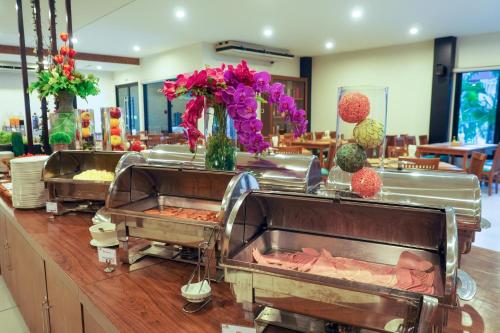 a buffet in a restaurant with two trays of food at Chaolao Cabana Resort in Chao Lao Beach