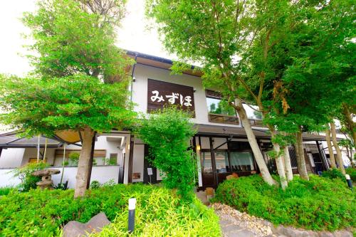 a building with trees in front of it at Good Stay Mizuho in Usa