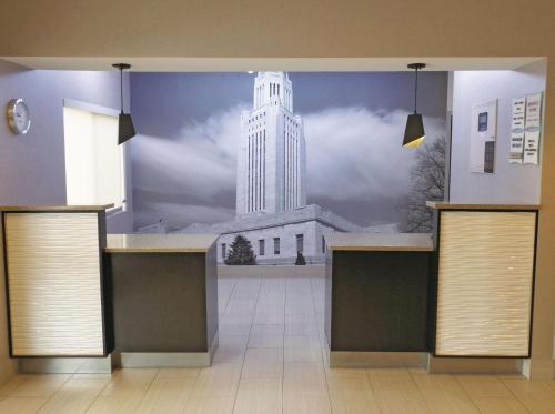 a wall with a mural of a white building at La Quinta Inn by Wyndham Lincoln in Lincoln