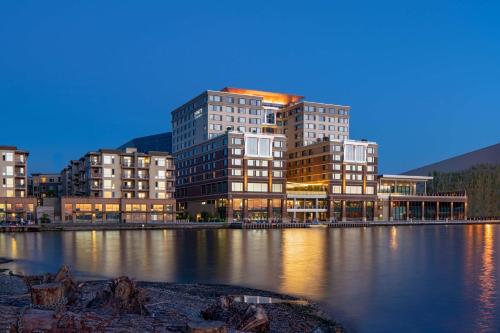 a group of tall buildings next to a body of water at Hyatt Regency Lake Washington at Seattle's Southport in Renton