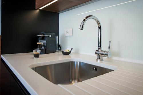 a kitchen sink with a faucet on a counter at The Q Superior - a penthouse with jacuzzi and sauna in Rovinj
