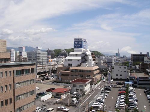 a city with cars parked in a parking lot at Hotel New Shizuoka in Shizuoka