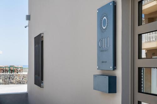 a door with a sign on the side of a building at Ciel Collection Suites in Chania Town