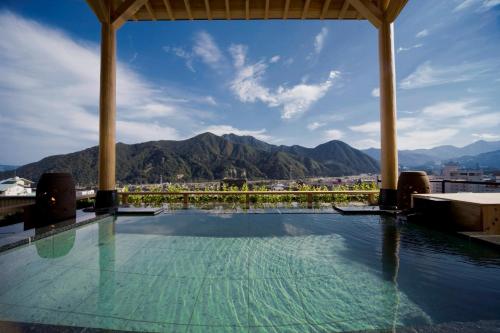 a swimming pool with a view of mountains at Hotel Futaba in Yuzawa