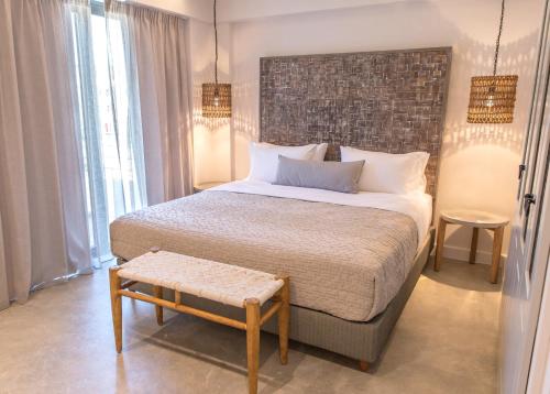 a bedroom with a large bed with a brick wall at Crystal Waters in Nikiana