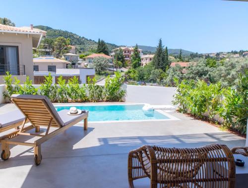 a villa with a view of a swimming pool at Crystal Waters in Nikiana