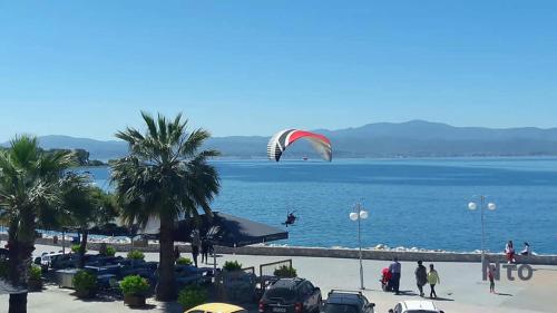 a person flying a kite over a body of water at Diamanto Rooms in Eretria