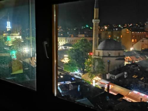 a view of a city at night from a window at Apartments Emily in Sarajevo