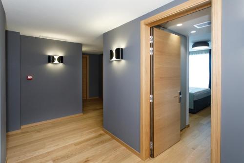 a hallway with a door and a room with a bed at Buzë Boutique Hotel in Sarandë