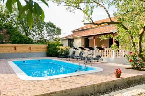 a swimming pool in the backyard of a house at Vacation home Duilo in Donji Zemunik
