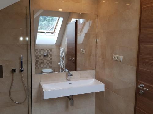 a bathroom with a sink and a mirror at Tündérlak Vendégház in Balatonfüred