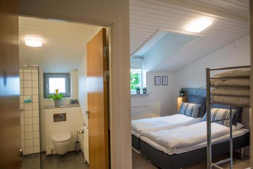 a bedroom with two bunk beds and a bathroom at Refborg Hotel in Billund