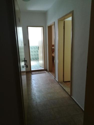 an empty hallway with a door leading to a room at Hotel Diva in Ravda