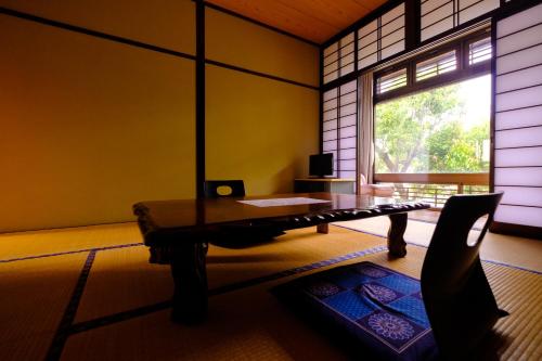 a living room with a table and a window at Good Stay Mizuho in Usa