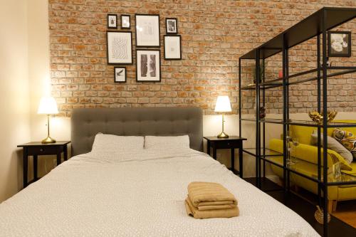 a bedroom with a bed and two tables with lamps at Stylish Flat in the Heart of Historical Center in Timişoara