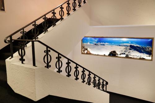 a set of stairs with a picture on the wall at Hotel Ratschingserhof in Racines