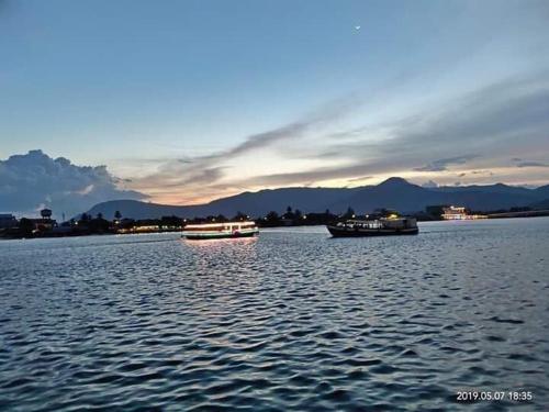 two boats on a large body of water at TWIN HOME Guesthouse in Kampot