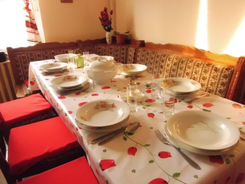 a table with plates and utensils on top of it at Nagyiék háza / Granny's House in Esztergom