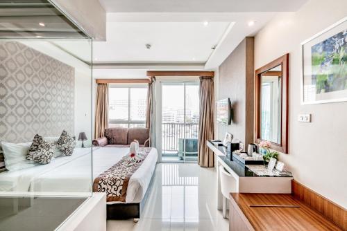 a living room with a bed and a couch at 247 Boutique Hotel in Pattaya Central