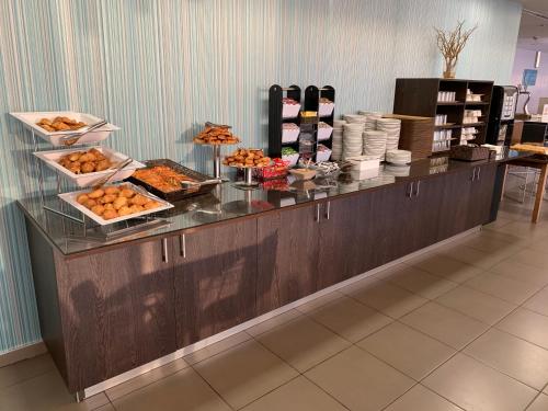 a buffet line in a restaurant with food on it at Holiday Inn Express Vitoria by IHG in Vitoria-Gasteiz