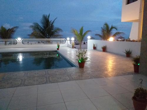 a view of a swimming pool at night at Salalah Beach Villas in Salalah