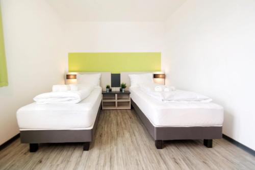 Säng eller sängar i ett rum på bestprice Hotel Eschweiler