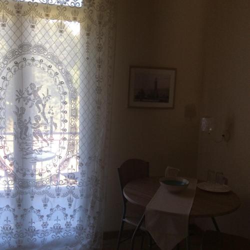 a room with a table and a window with a curtain at The Magic Mountain in Tsapournia