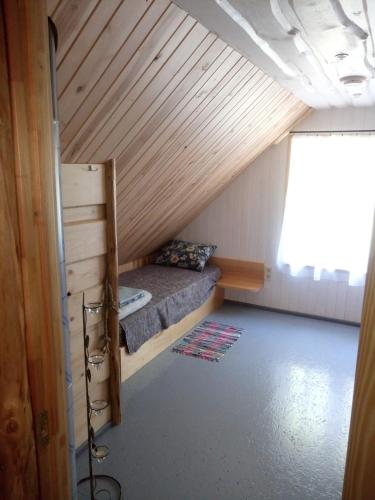 a small room with a bed in a attic at Jēkaba māja in Balvi