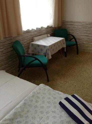 a room with two chairs and two tables and a window at Ubytování Zmatlíková in Pec pod Sněžkou
