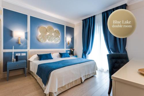 a bedroom with a blue lake drink room at Madrigale Panoramic&Lifestyle Hotel in Costermano