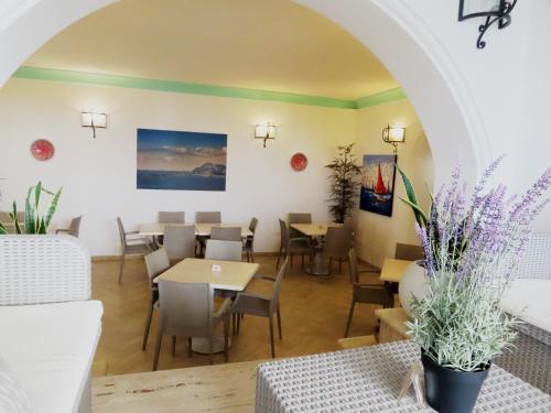 a restaurant with tables and chairs in a room at Hotel Ossidiana Stromboli Center in Stromboli