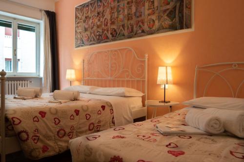 um quarto de hotel com duas camas e uma janela em B&B Forever em Verona