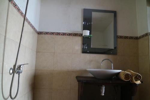 a bathroom with a sink and a shower with a mirror at Batur Green Lakeview in Kintamani Bali in Kintamani