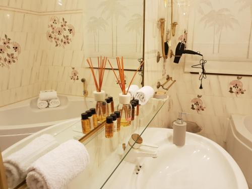 ein Badezimmer mit einer Badewanne, einem Waschbecken und einem Spiegel in der Unterkunft Olguita in Menton