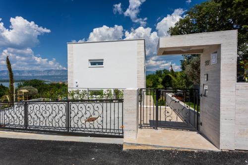 a building with an open gate with a view at Villa Zarra in Klimno