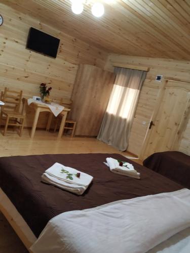 a bedroom with a bed with towels on it at Green Villa Tskaltubo in Tskaltubo