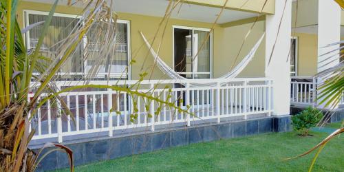 a front porch of a house with a hammock at Atlantic Palace Family inn in Aquiraz