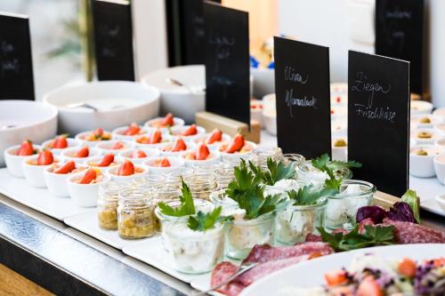 a buffet of food on a table with plates of food at Gästehaus Rössler in Brannenburg