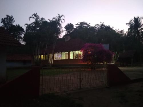 a house with a fence in front of it at Woodside Homestay Wayanad in Batheri