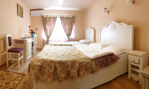 a bedroom with a large bed and a window at Leaganul Bucovinei Guest House in Suceava
