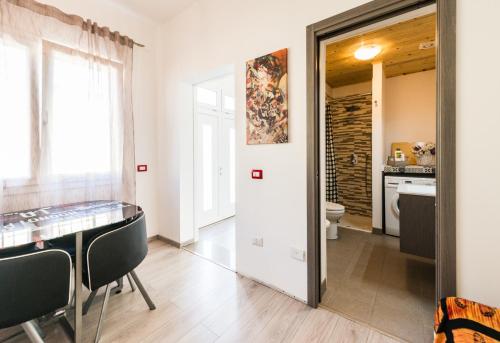 a dining room with a table and a mirror at Geco's Apartment in Elmas