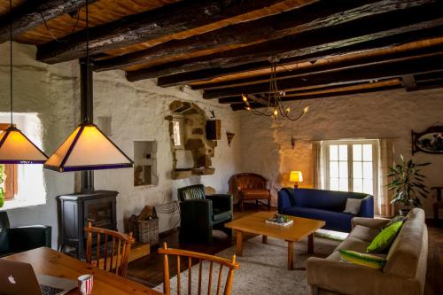 a living room with a couch and a table at Les Cavaleries in Nonards